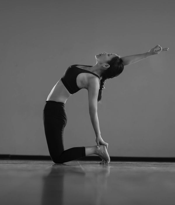 Woman in a graceful yoga pose, finding balance and calm.
